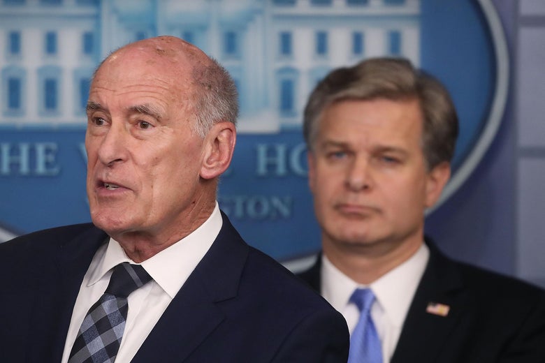 Dan Coats and Christopher Wray in White House briefing room.